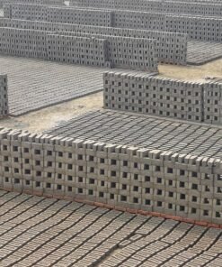 Concrete blocks curing in a brick production yard, produced by a hydraulic press machine