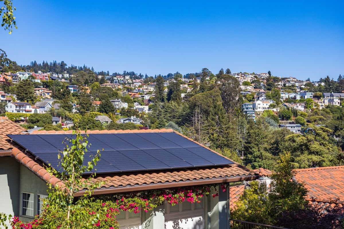 Solar panels on a rooftop under a clear sunny sky