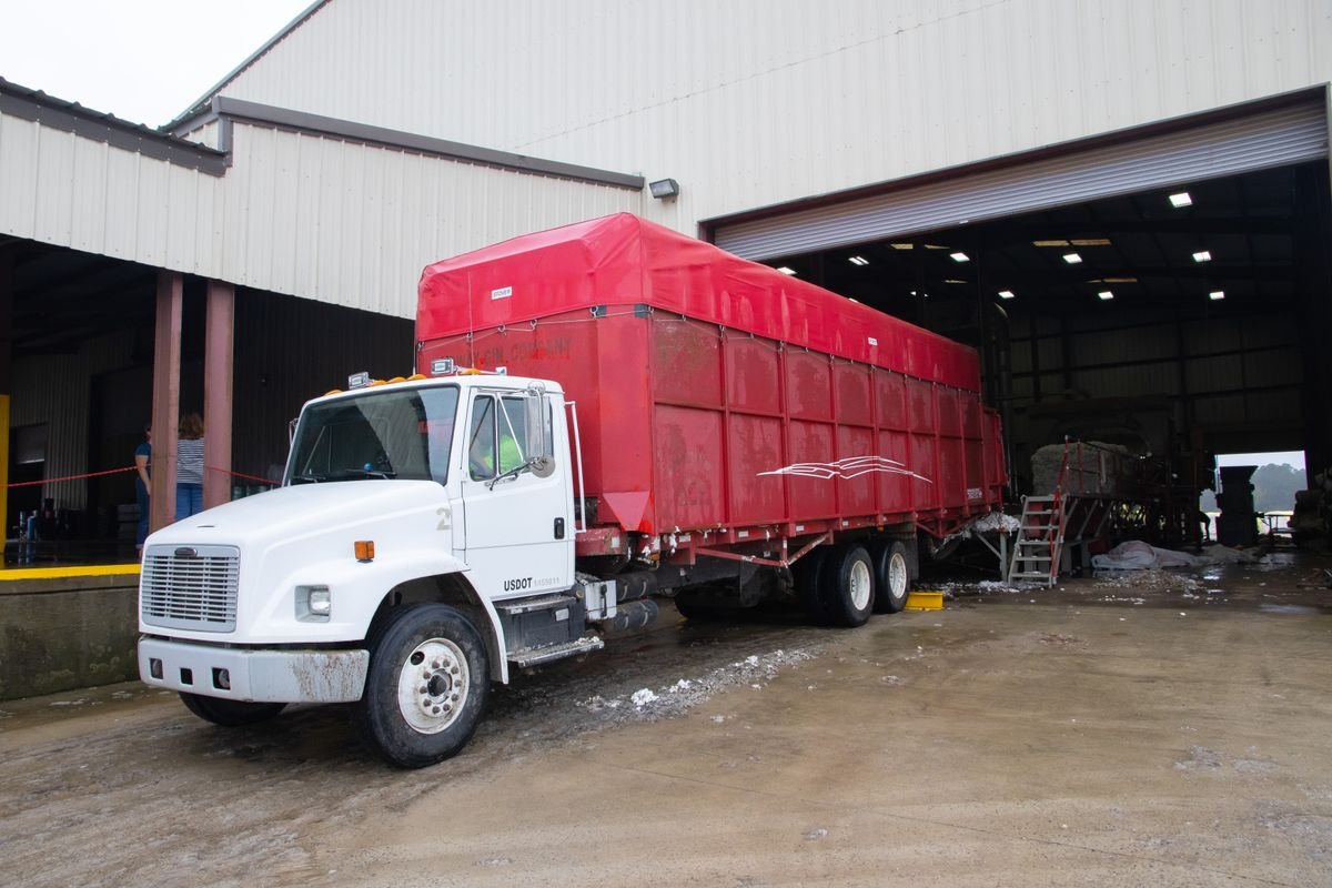Covered cargo truck parked at a warehouse loading bay