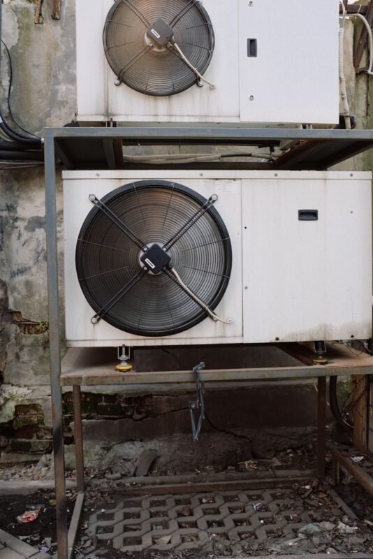 Close-up of industrial air-cooled refrigeration condenser fan units