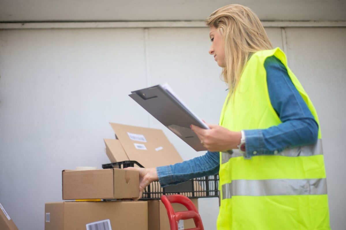 Worker reviewing boxes and documentation for re-export processing