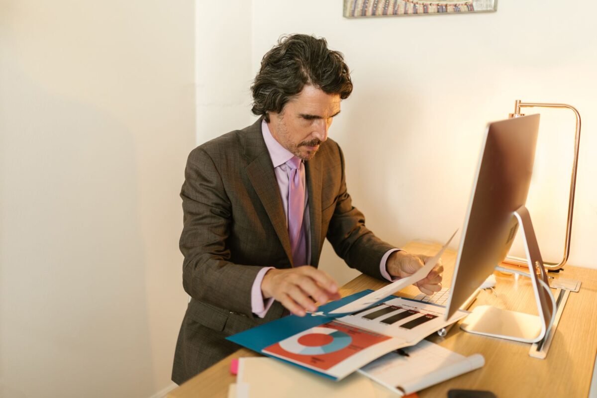 Businessman reviewing import documents and customs paperwork at his desk
