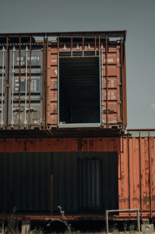 Weathered stacked shipping containers in a storage yard