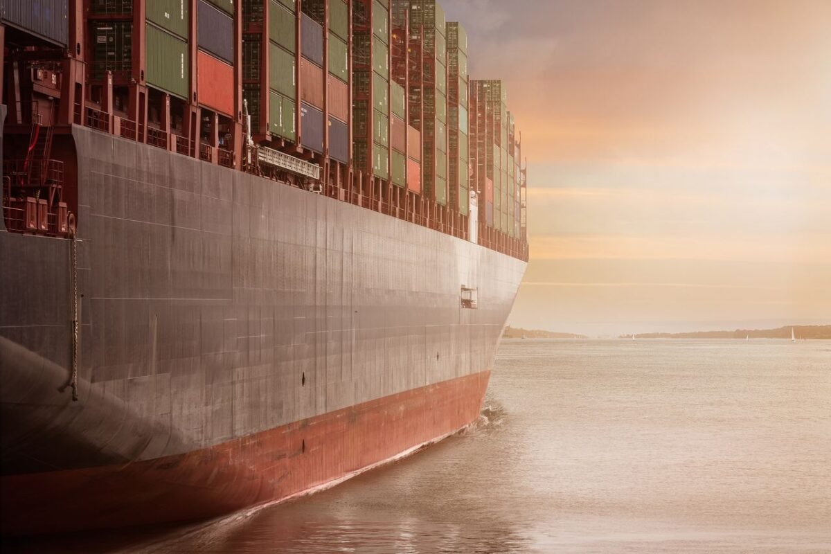 Loaded container ship under way at sunset