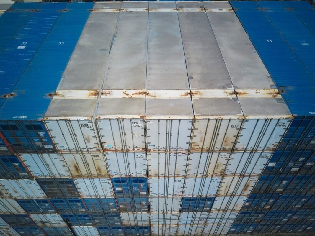 Aerial view of stacked shipping containers at a logistics yard