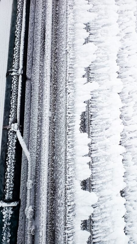Heavy frost buildup on metal pipes