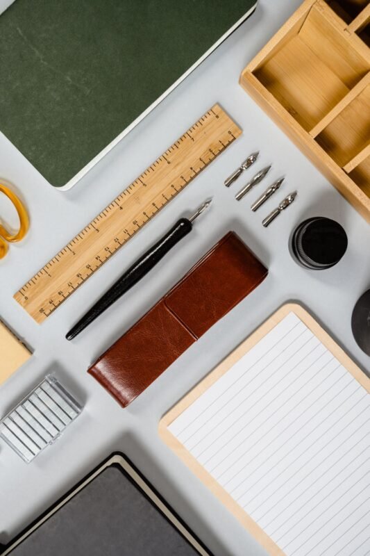 Notebooks, ruler, pen, staples and desk organiser