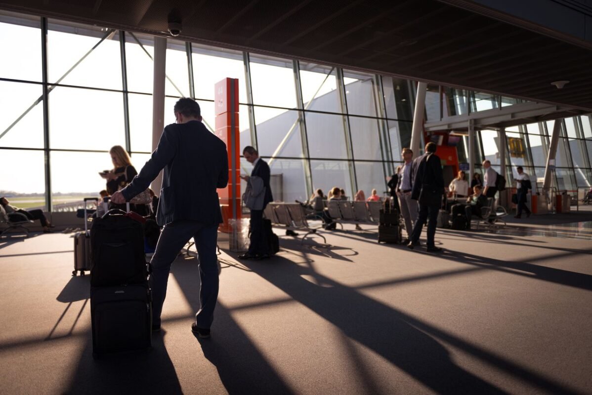 Travellers with suitcases in an airport terminal