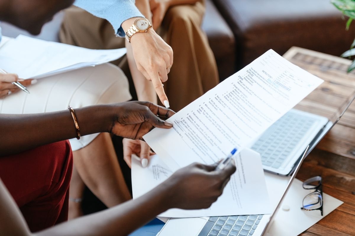 Two people checking a company registration document