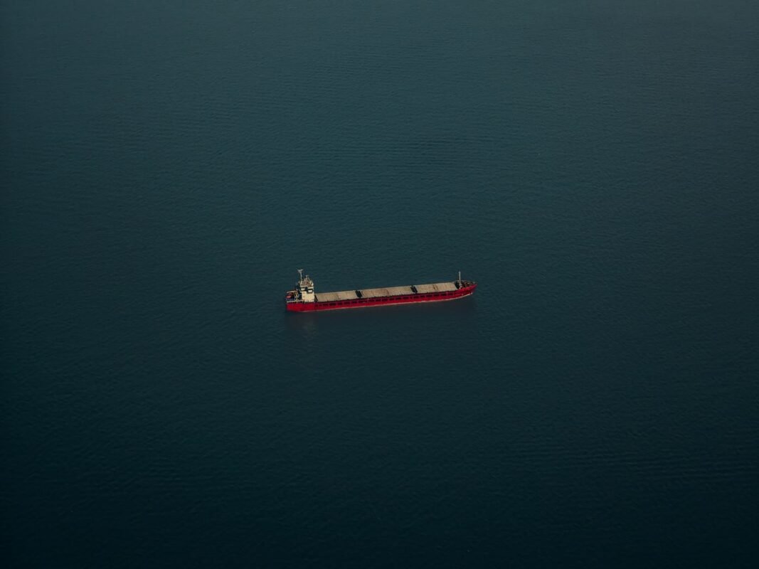Aerial view of a cargo ship sailing alone on calm open sea