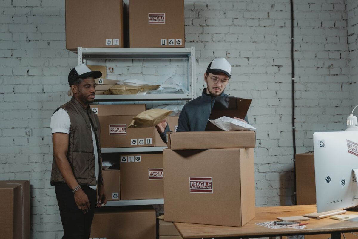Warehouse workers checking cartons unloaded from a container