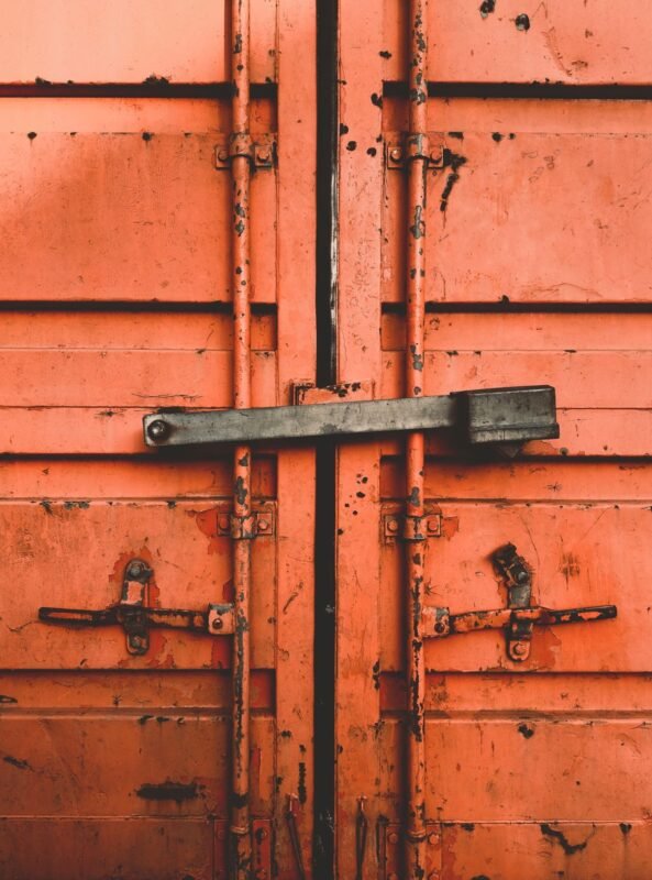 Weathered container doors secured with a steel locking bar