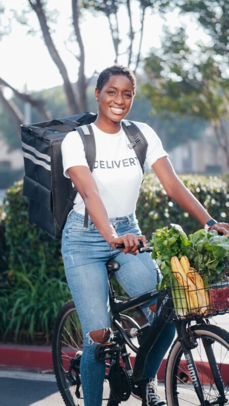 Grocery delivery rider with an insulated bag and fresh produce
