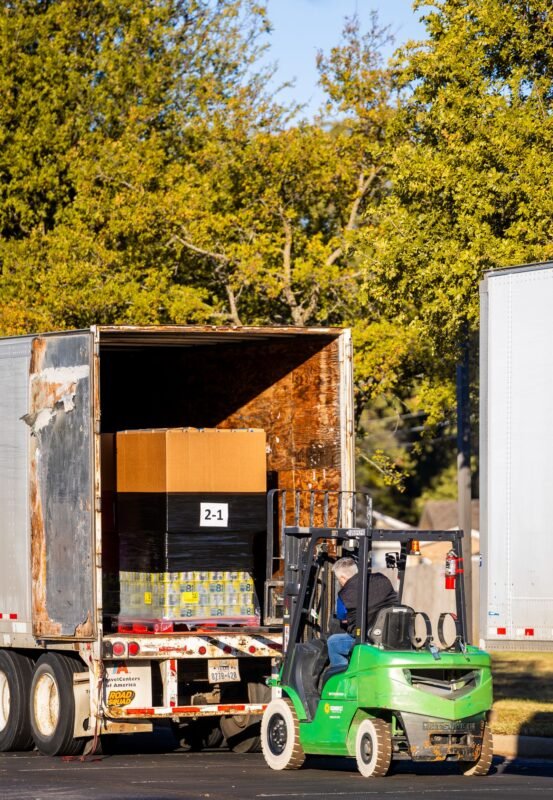 Forklift loading a checked, palletised order into a delivery truck