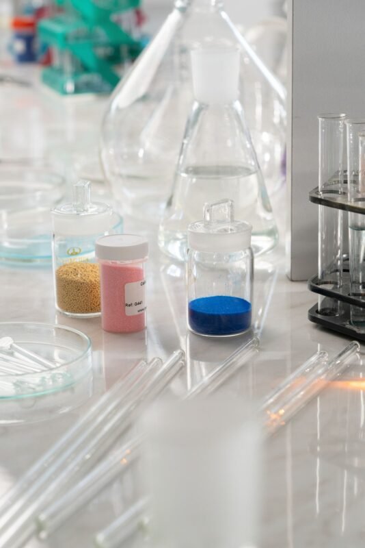 Chemical powder samples in glass jars in a testing laboratory