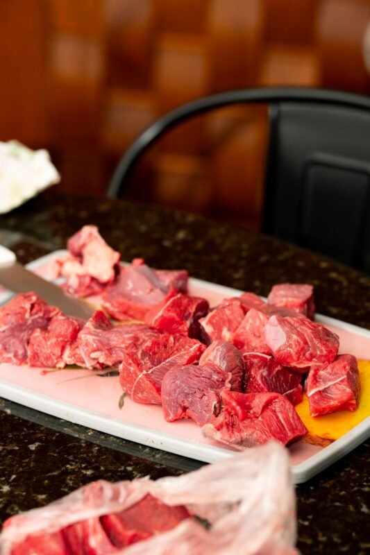 Fresh cut beef pieces on a tray ready for chilling or freezing