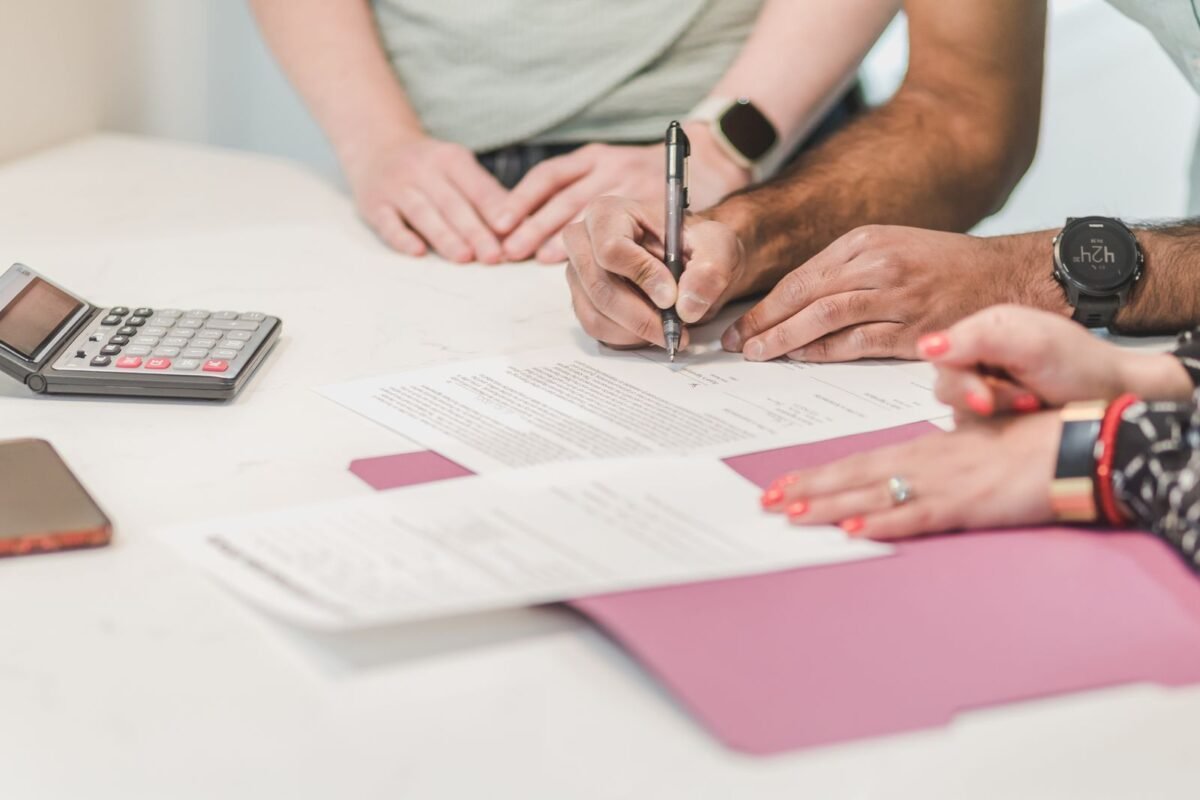 Reviewing and signing import finance paperwork at a desk