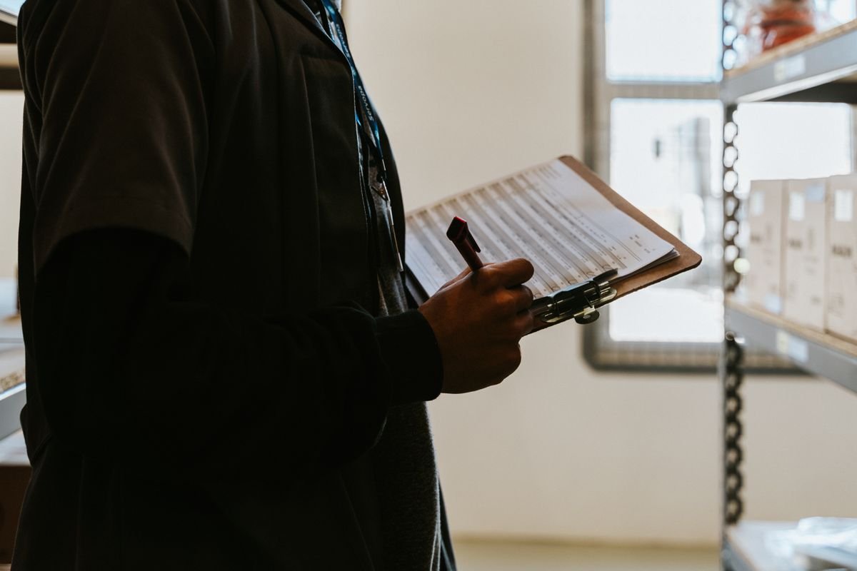Warehouse worker checking inventory on a clipboard
