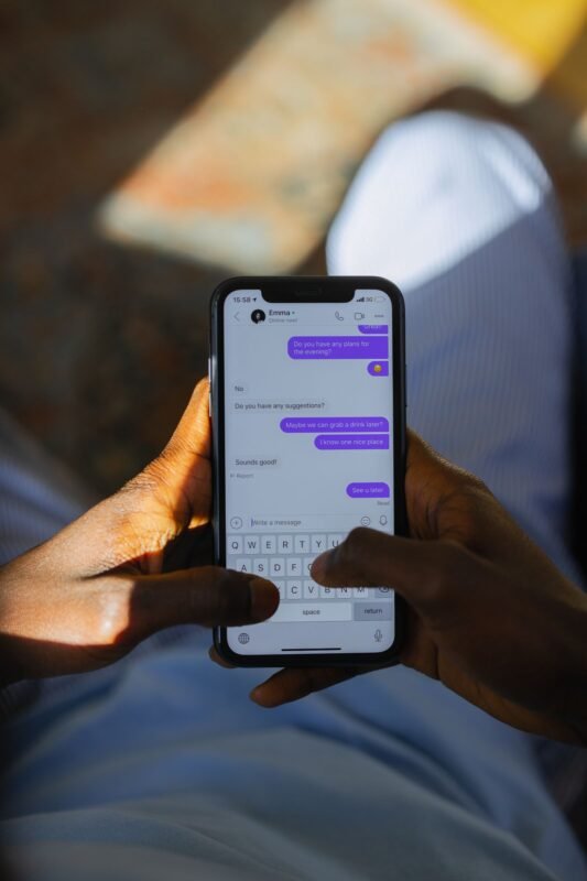 Importer messaging a supplier on a smartphone to confirm order details