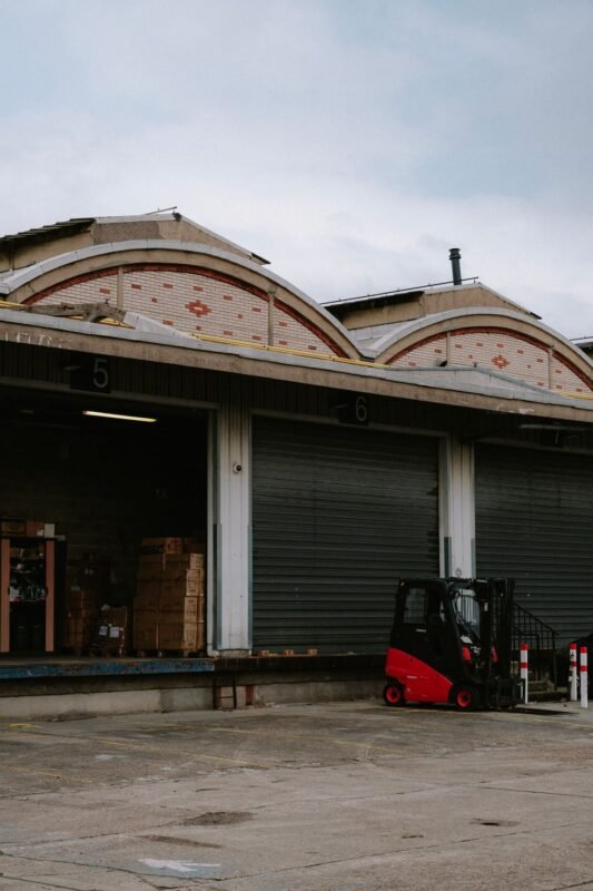 Forklift positioned at a warehouse loading dock bay