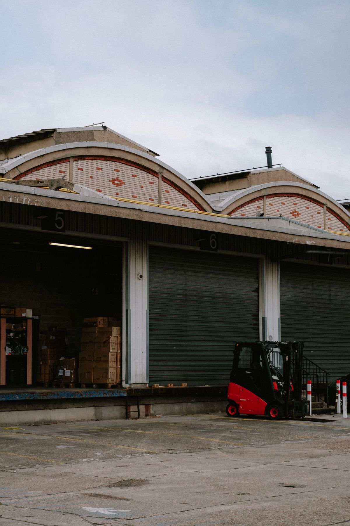 Forklift positioned at a warehouse loading dock bay