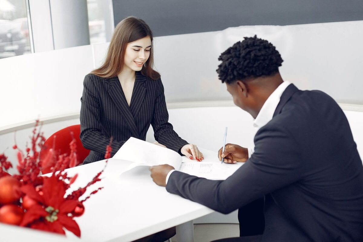 Bank officer and client reviewing import finance paperwork