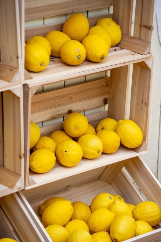 Fresh lemons stacked in wooden crates