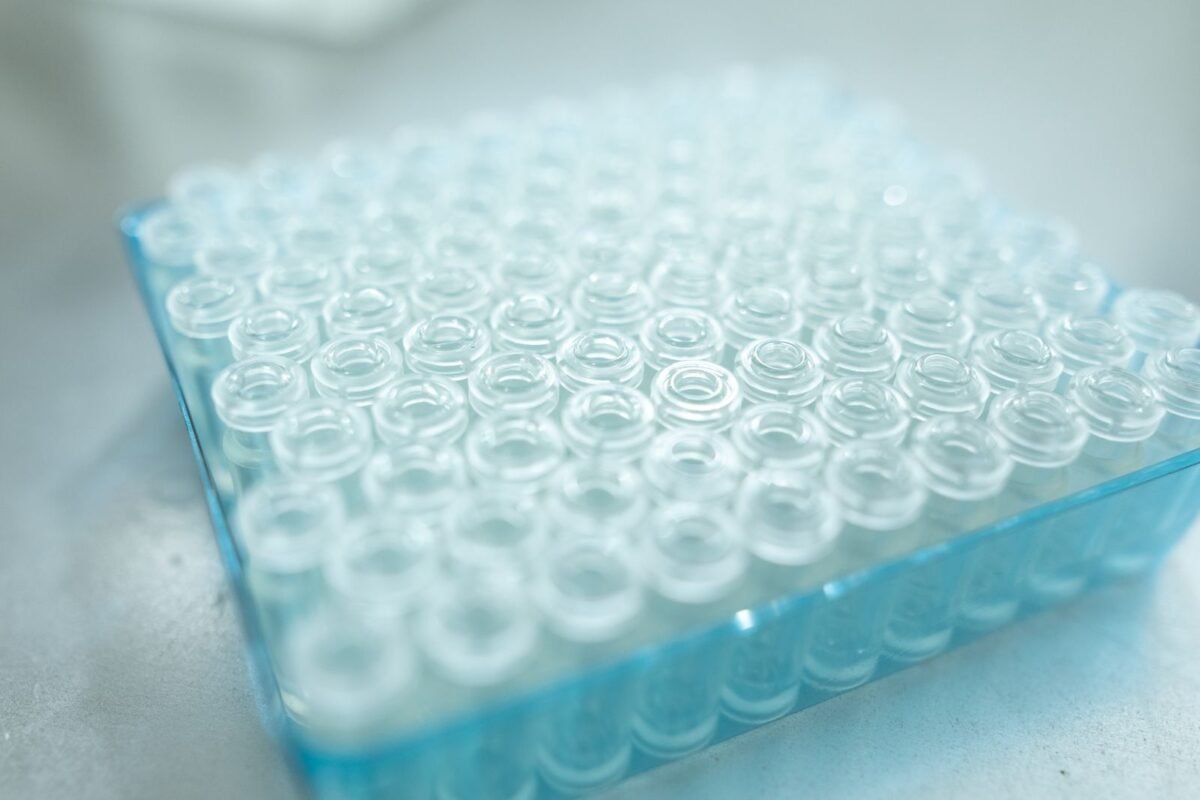 Close-up of empty glass sample vials arranged in a laboratory tray