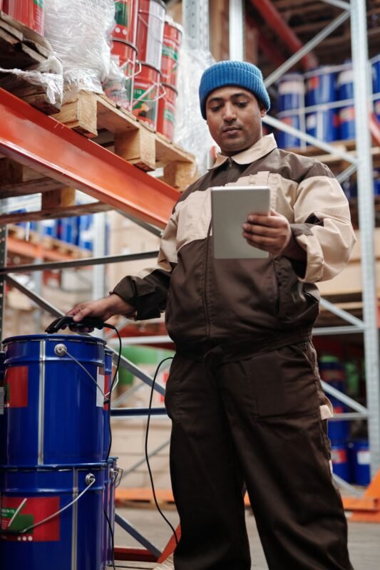 Warehouse Worker Checking Stock Data on a Tablet