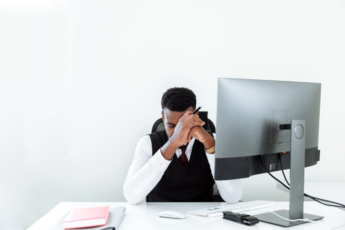 Stressed Office Worker Reviewing a Rejected Document at Desk