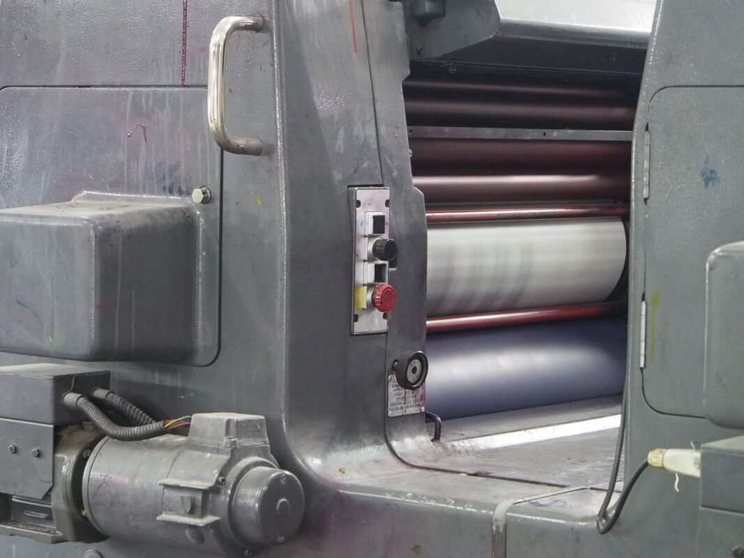 Close-up of an offset printing press cylinder and control panel