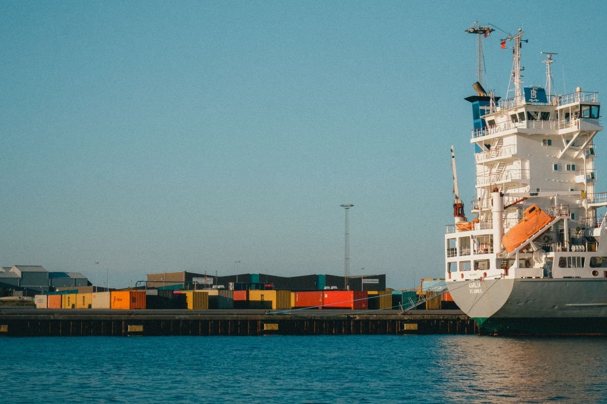 Container feeder vessel berthed at a port quay