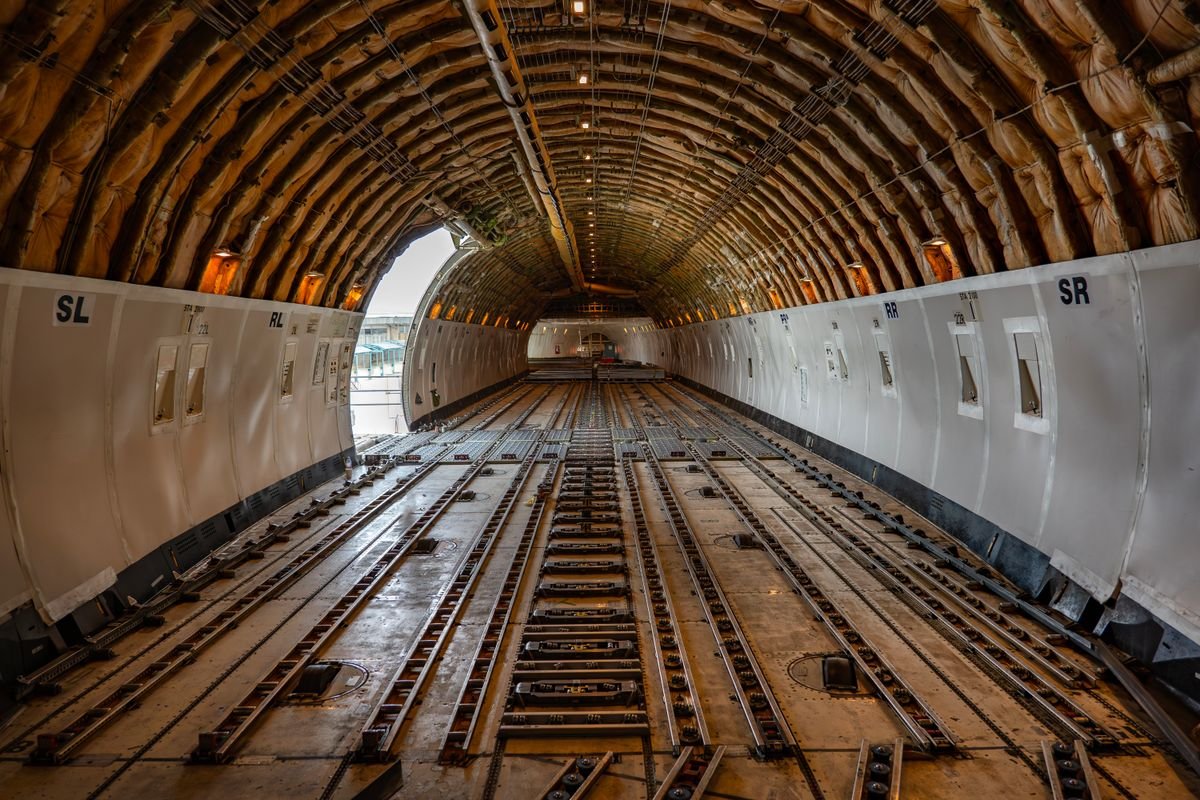 Empty main deck cargo hold of a freighter aircraft with position markings