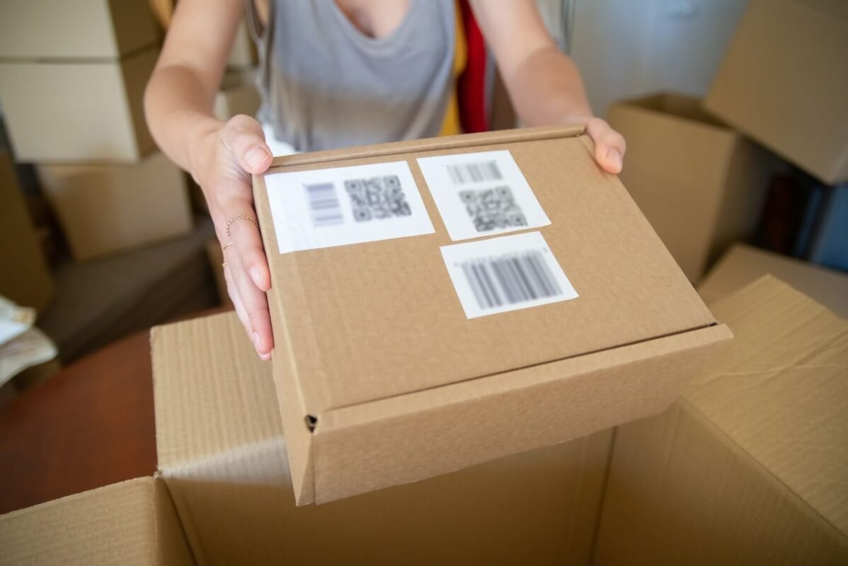 Carton with barcode and QR labels applied in a warehouse