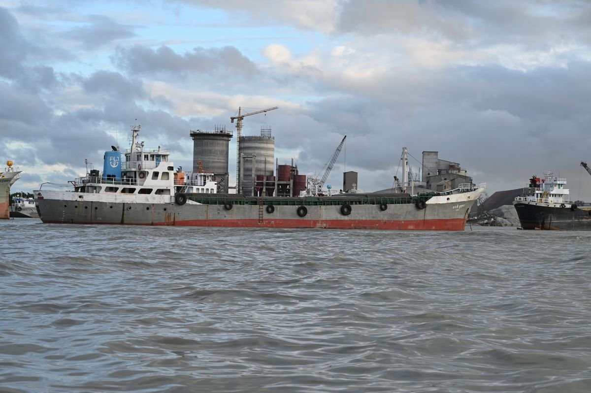 Cargo vessels moored at Chattogram port under an overcast sky