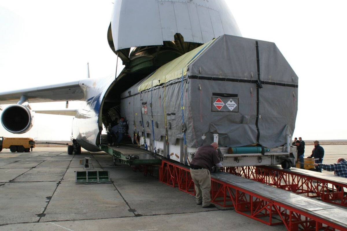 Oversized cargo being loaded into the nose door of a chartered freighter aircraft