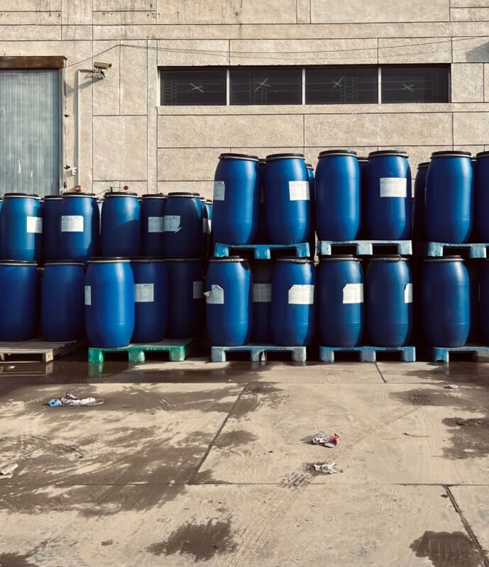 Blue Chemical Drums Stacked on Pallets