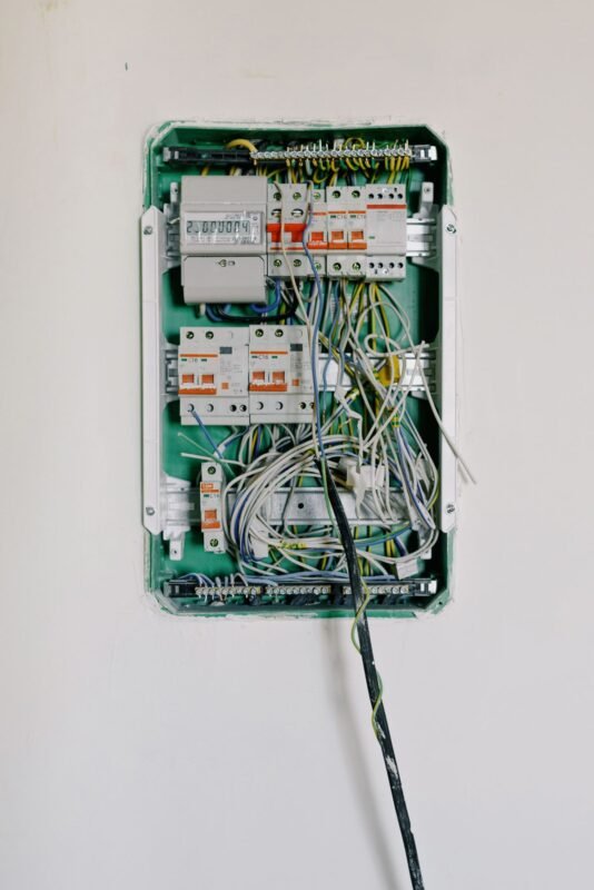 Wall-mounted electrical distribution board with circuit breakers and wiring