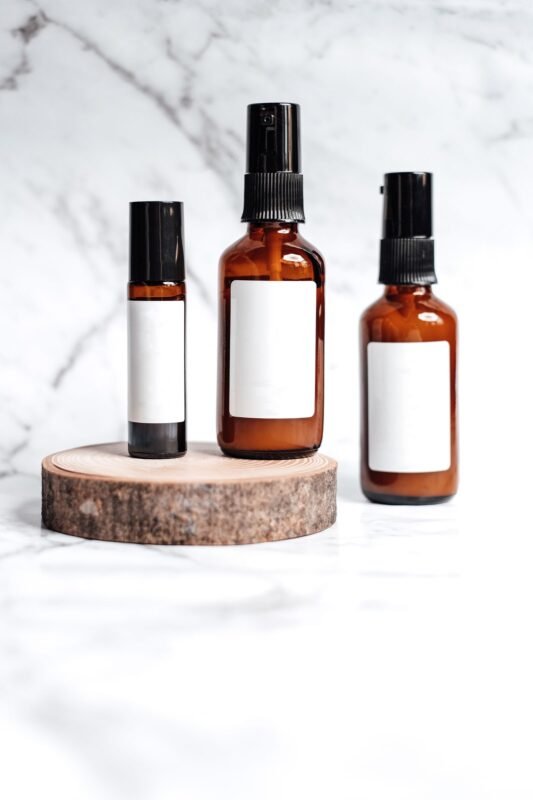 Blank-label amber glass spray and roll-on bottles for perfume and attar