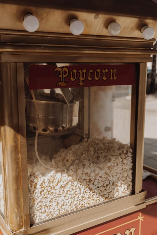 Commercial popcorn machine kettle with freshly popped popcorn