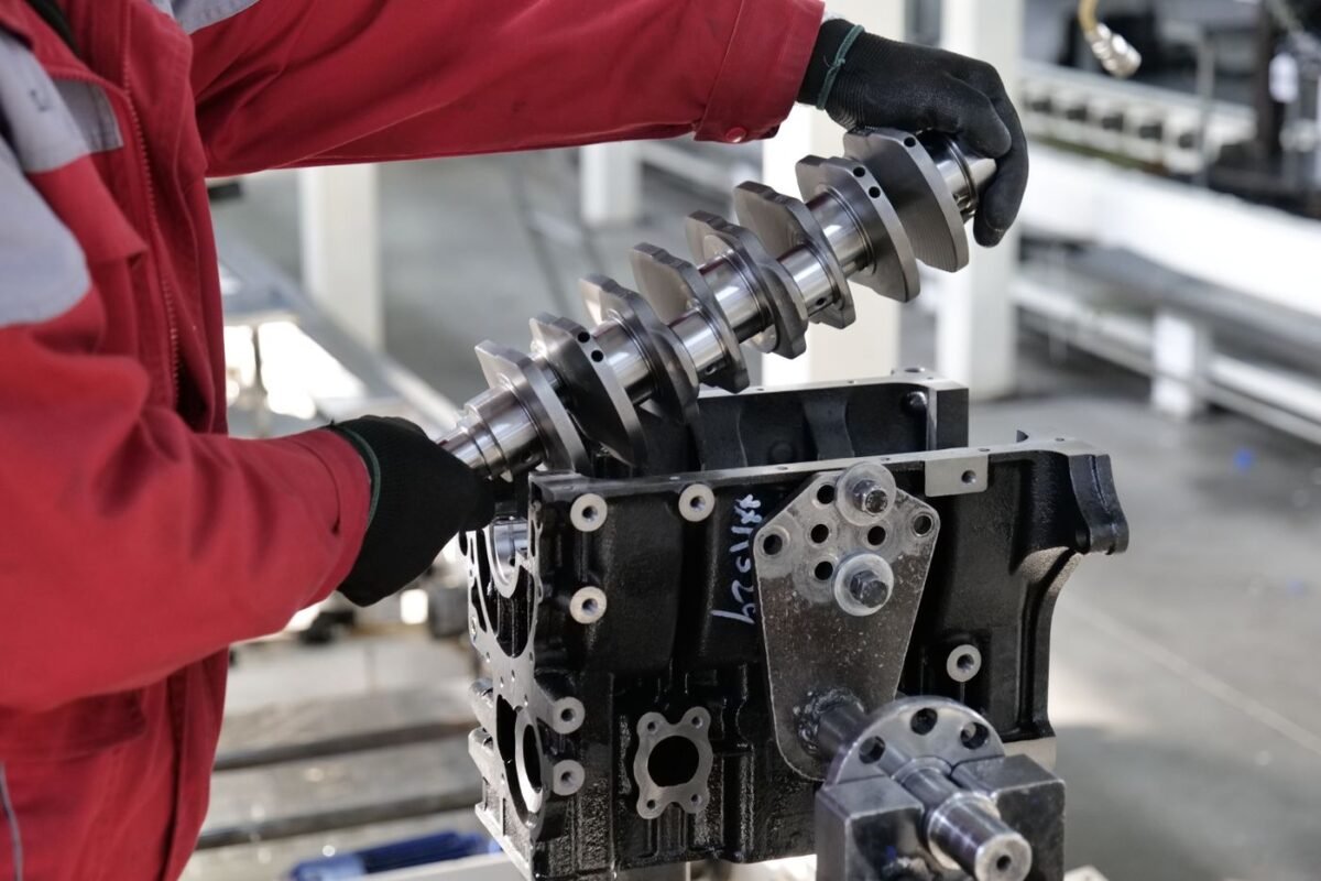Technician fitting a crankshaft into an engine block