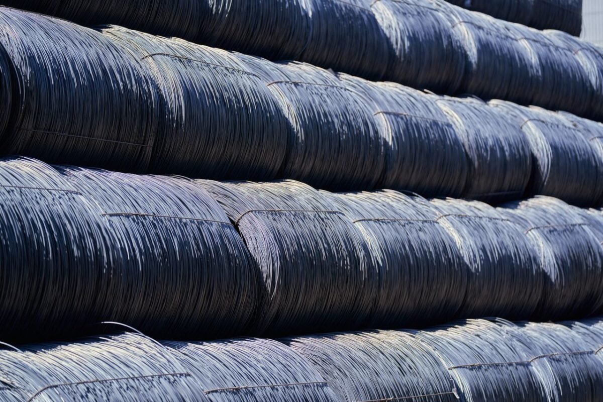 Stacked steel wire coils, a raw material whose price moves supplier quotes