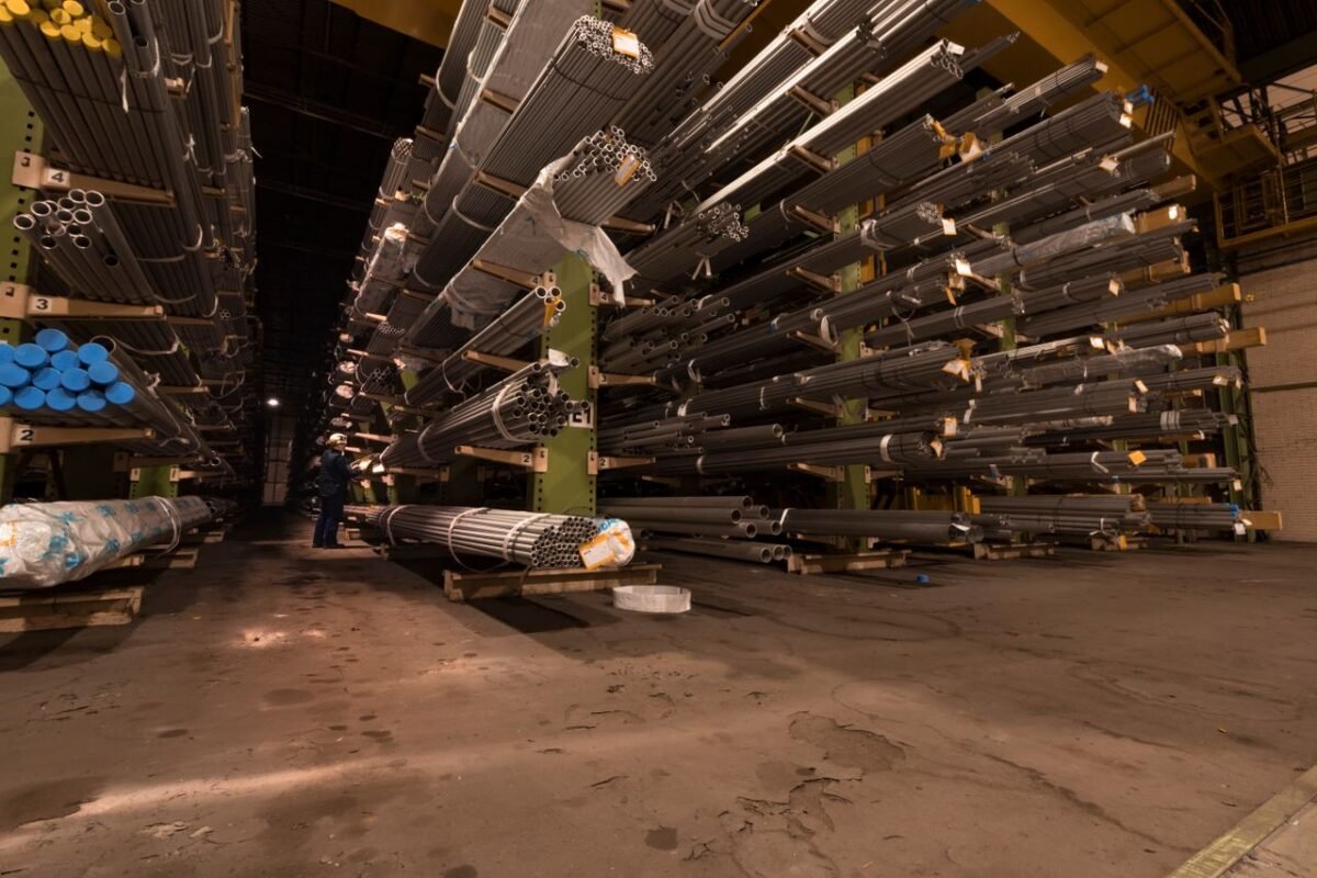 Steel pipes stored off the floor on cantilever racks inside a warehouse