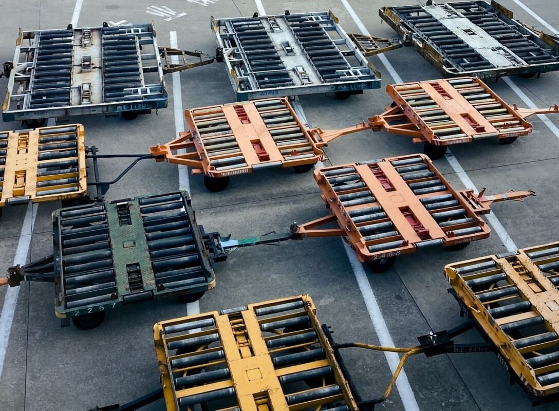 Air cargo pallet dollies with roller beds parked on an airport apron