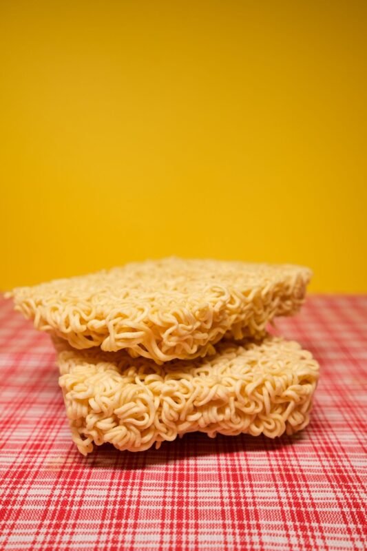 Blocks of dried instant noodles stacked on a table
