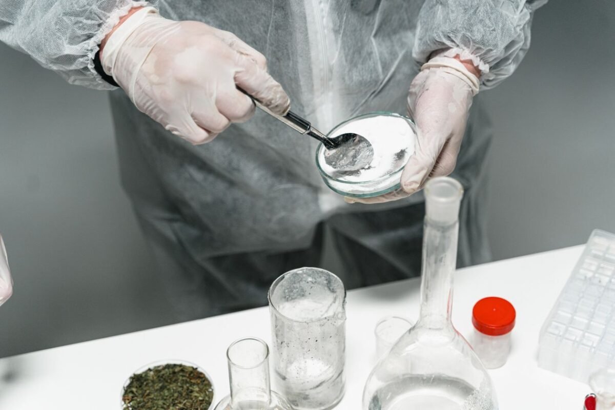 Technician testing a white food additive powder sample in a laboratory