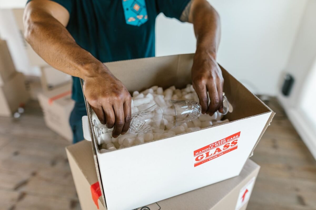 Packing glassware into a carton with loose fill