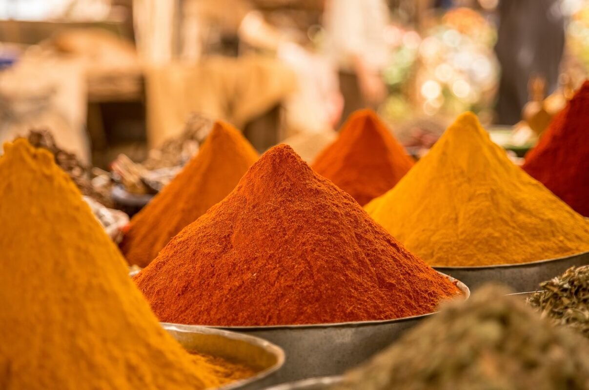 Heaps of ground chilli and turmeric powder at a spice stall
