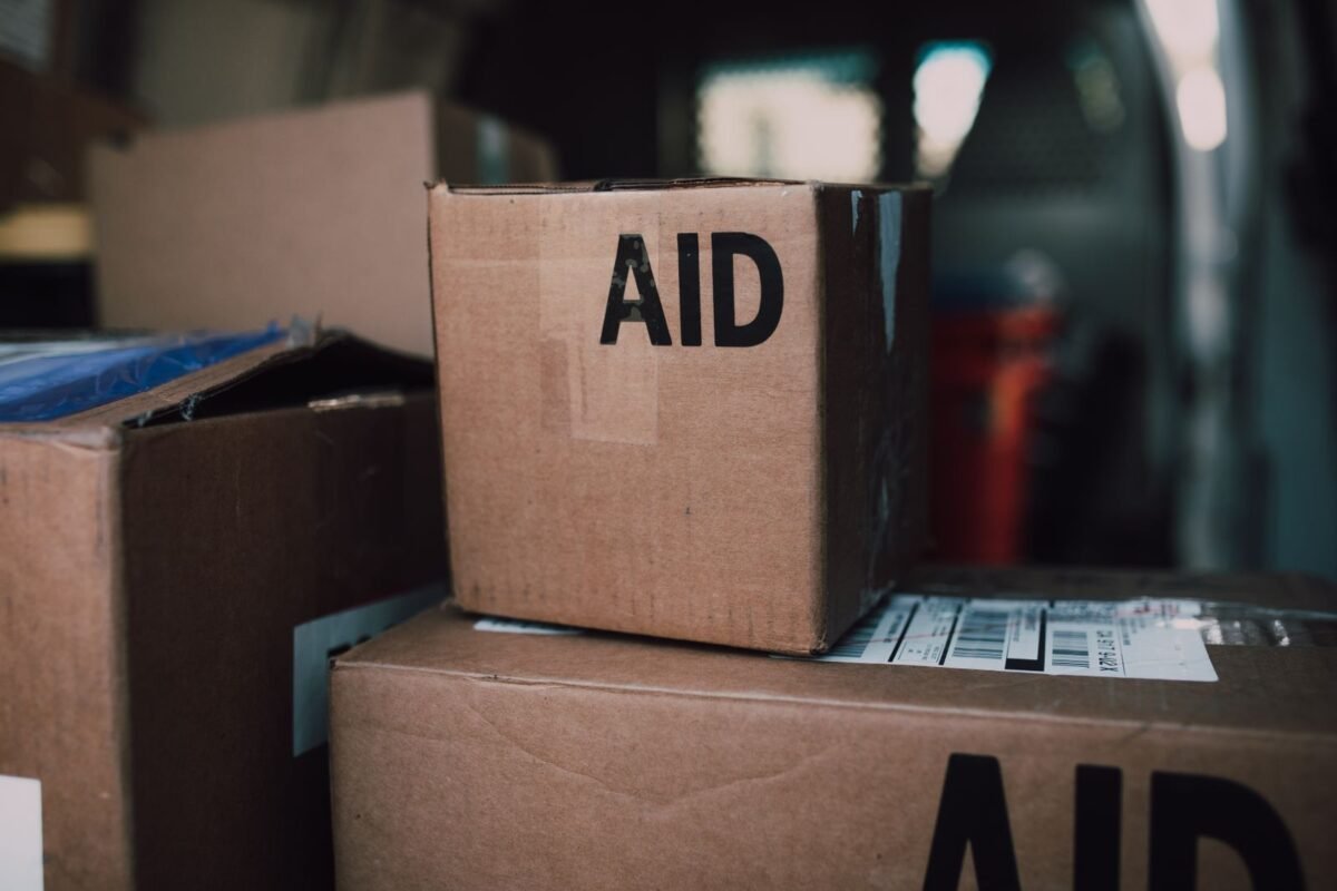 Cartons marked AID stacked for relief distribution