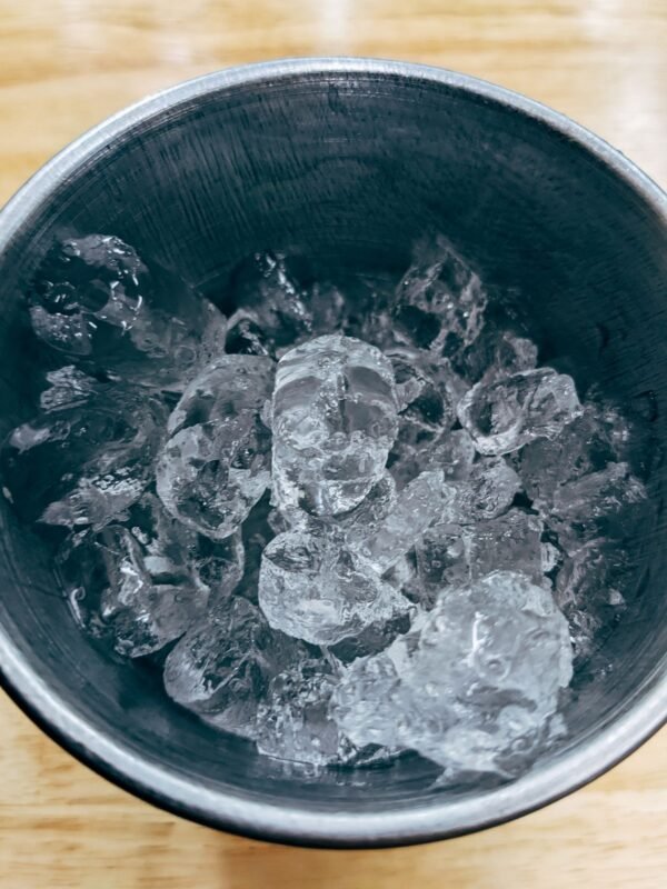 Clear ice in a stainless steel bucket